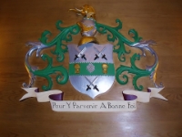 The Cutlers' Coat Of Arms In Wood.  The coat of arms and motto carved in wood.