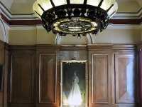The Portrait Of The Queen.  The large chandelier, the portrait of the Queen and the large mirror at the head of the first flight of stairs on the grand staircase.