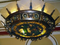 The Chandelier Over The Stairs.  A close up of the chandelier showing the coat of arms and the motto.